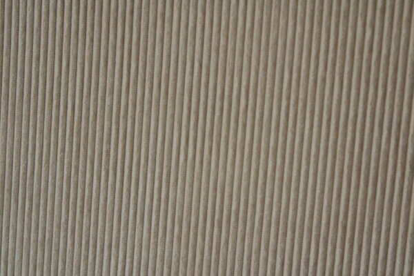 Detail van het crèmekleurige Corduroy gordijn, toont de fijne ribbels en hoogwaardige afwerking van de stof.