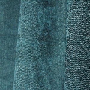 Petrolkleurige gordijnen uit de Imperial-collectie in close-up met zichtbare structuu