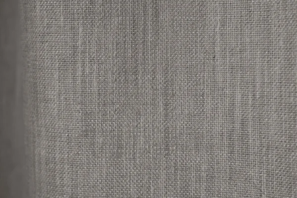 Detail foto patroon van het weefpatroon van de lichtgrijze inbetween gordijnen met een elegante textuur.