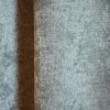Close-up van de groengrijze velours gordijnstof van Okika, met zichtbare stofdetails zoals het subtiele krijt-effect en de zachte, luxueuze textuur.