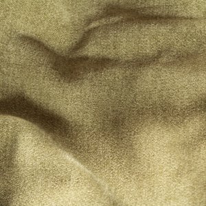 Detail van pistachekleurige chenille vouwgordijnen met zachte structuur