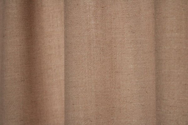 Sfeerfoto van beige gordijnen uit de Elegance collectie, model JC2548 Okika. De semi lichtdoorlatende stof laat natuurlijk licht door. Slijtvast en kleurvast met een zachte, geweven textuur.