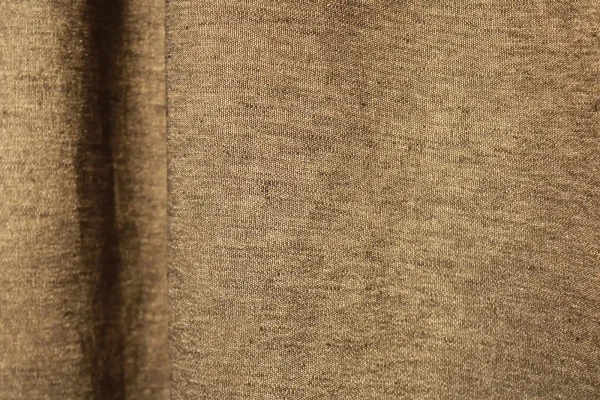 Stofdetails van de bronzen linnen gordijnen met lurex uit de Okika collectie, met zicht op de warme kleurtint, linnenstructuur en subtiele metallic glans.