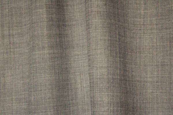 detailfoto van de stof van grijsblauwe gordijnen uit de Florain collectie (JC2521) van Okika, met een subtiele weefstructuur.