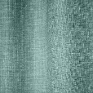 Sfeerfoto van turquoise gordijnen uit de Florain collectie (JC2526) van Okika, die de ruimte een frisse sfeer geven, semi licht doorlatende stof en kleurvast
