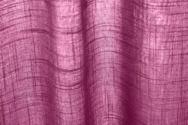 Structuurfoto van het aubergine kleurige gordijn REY2566 uit de Saphira Light collectie van Okika, in het licht met zichtbare weving en lichtdoorlatende stof.