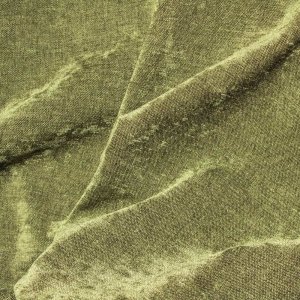 Detail van de gedraaide stofstructuur van groene chenille gordijnen