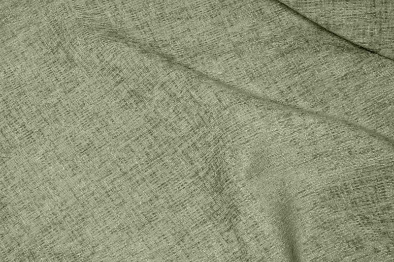 sfeerfoto van mintgroene vouwgordijnen uit de teddy chenille collectie waarbij de stof in elkaar is gevouwen