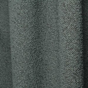 Donkerblauwe bouclé gordijnen met bolletjes structuur op een stijlvolle interieur sfeerfoto met plooi