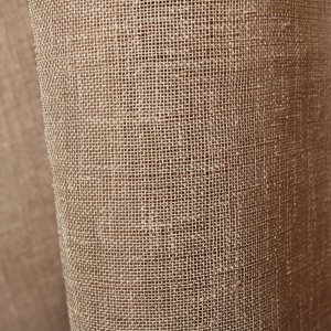 Detail van greige vitrage in een warme mix van beige en grijs met een fijne weefstructuur.